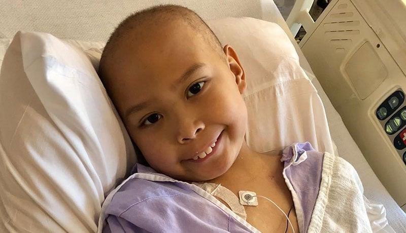 Child in hospital bed while receiving cancer treatment.